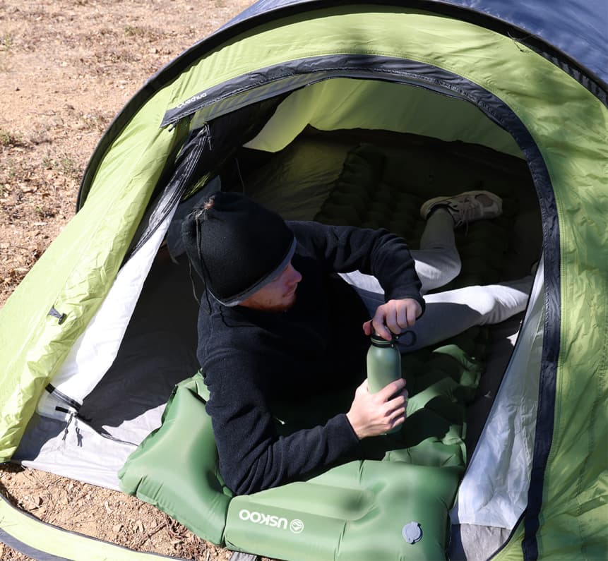 Relaxing on an AirFlex pad inside a tent Image