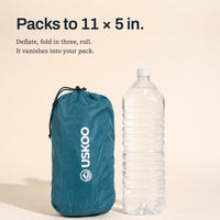 Packs to 11 x 5 in — Uskoo AirFlex in its stuff sack next to a 2-liter water bottle for scale