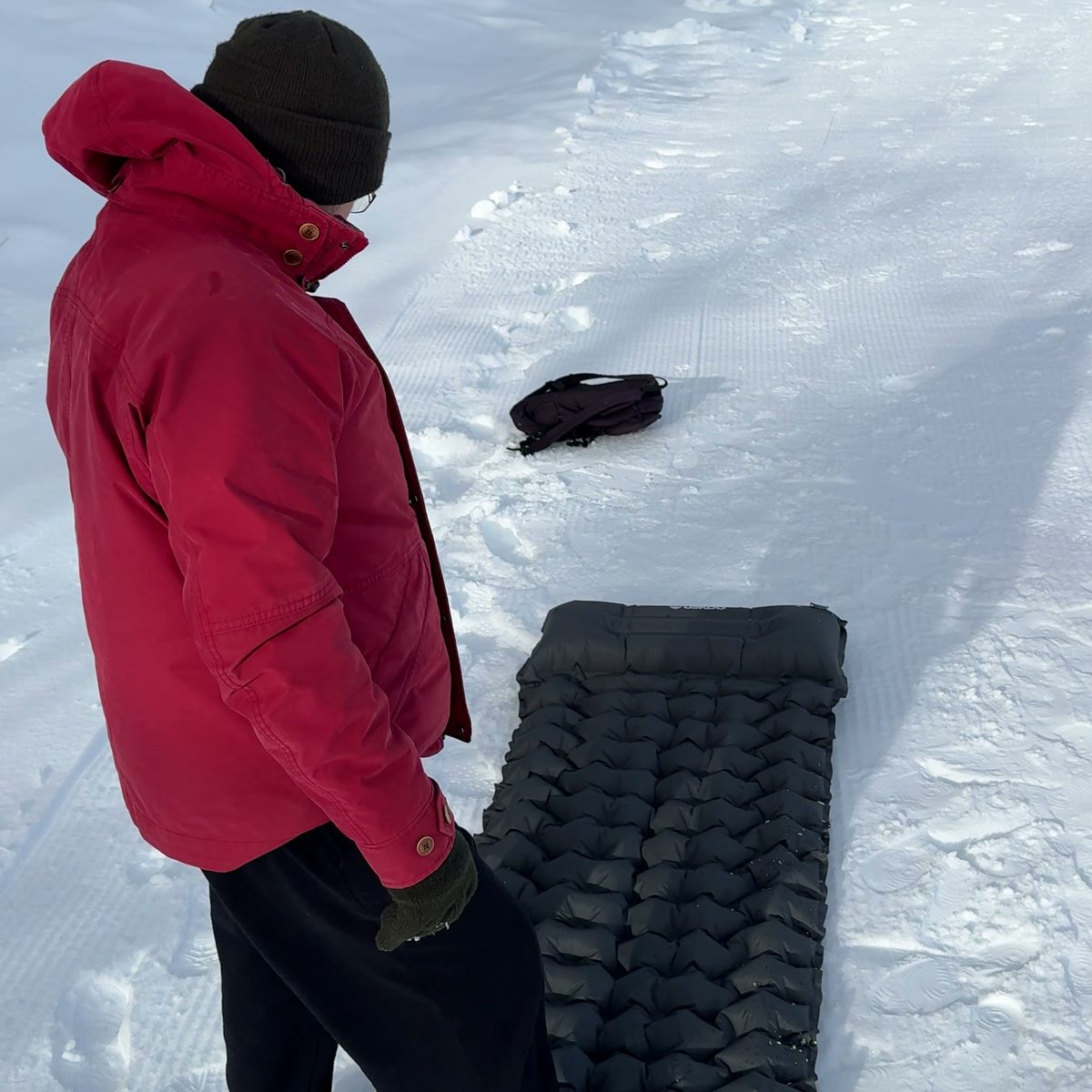Inflating the AirFlex with the built-in foot pump in the snow Image