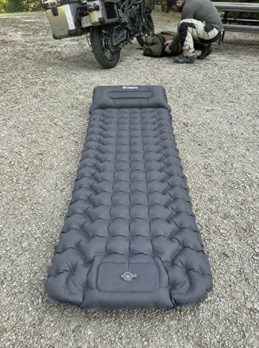Customer photo: grey Uskoo AirFlex pad laid out on gravel next to a motorcycle